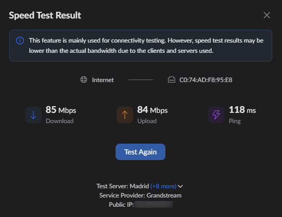 Speed test result dialog showing Download 85 Mbps, Upload 84 Mbps, Ping 118 ms, a Test Again button, and Madrid server details (Grandstream) with public IP hidden.
