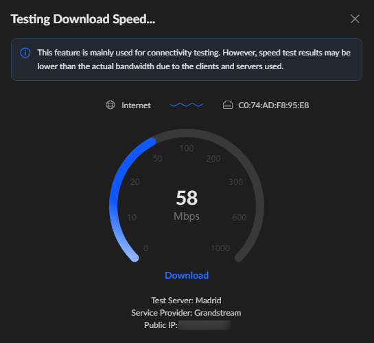 Dark speed-test dialog with a circular gauge showing 58 Mbps download speed and a blue arc; a Download button sits below, with Madrid server and Grandstream as the provider.